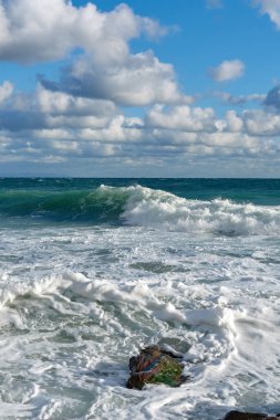 Denizde fırtına, mavi gökyüzünde bulutlar