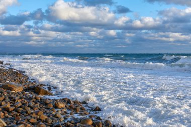 Denizde fırtına, mavi gökyüzünde bulutlar