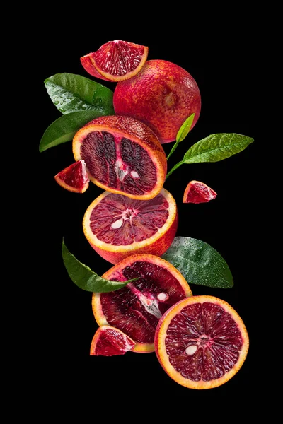 Blood Oranges Soaring Air Citrus Leaves High Resolution Black Background — Stock Photo, Image
