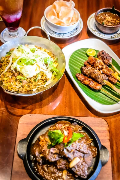 Fine dining Indonesian dishes spread out over table — Stock Photo, Image