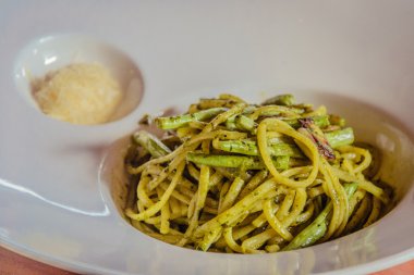 Makarna al pesto ile yeşil fasulye hizmet ve rendelenmiş parmesan