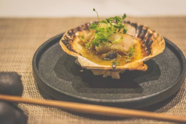 Hokkaido deniz tarağı kara tabakta kabuklu yaki.