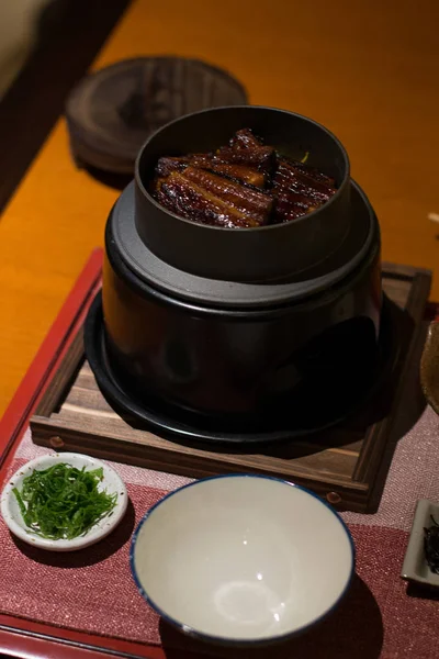 Anguille avec riz dans une petite casserole sur un petit poêle dans un restaurant — Photo