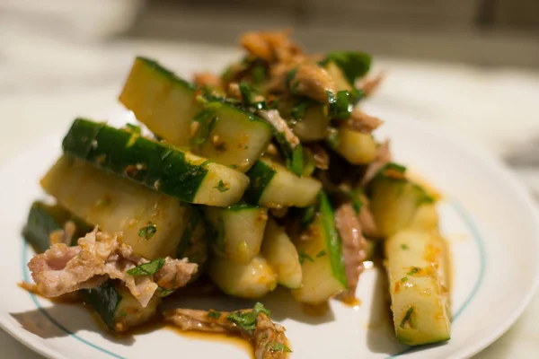 Spicy pulled pork and cucumber cold appetiser on a white plate — Stock Photo, Image