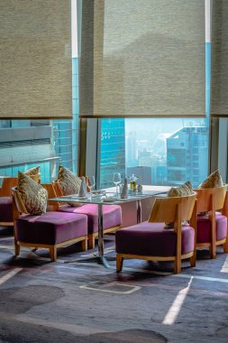 Yastıklı, çatal bıçaklı ve porselen takımlı güzel bir restoran masası.