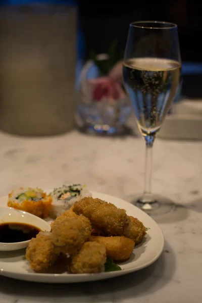 Assorted savoury and sweet fried pre-dinner canapes and sushi on a white plate — Stock Photo, Image