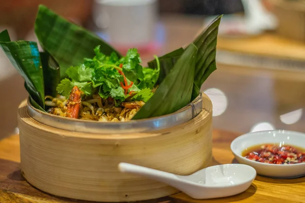 Fried char kway teow flat rice noodles with parsley on top and served in banana leaf in a bamboo basket — Stock Photo, Image
