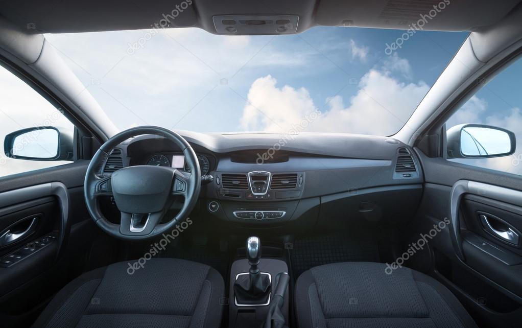 Car inside and sky with clouds