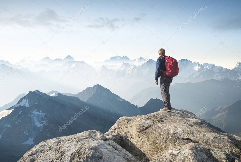 Tourist on the peak of high rocks