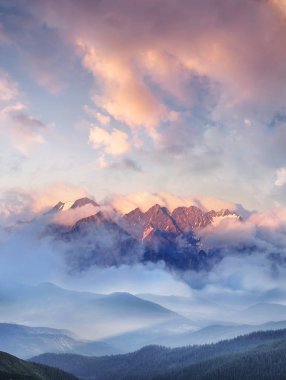 Mountain range in the clouds.  clipart