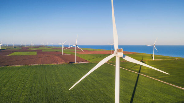 Wind power station in green field. Concept and idea of alternative energy development