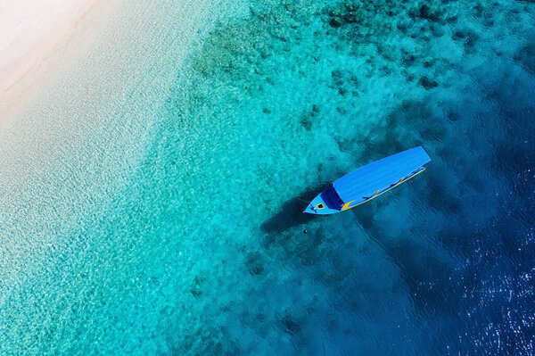 Boats on the water surface and beach from top view. Azure water background from drone. Summer seascape from air. Travel - image