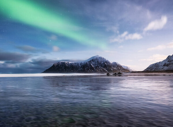 Aurora Borealis. Skagsanden beach on Lofoten Islands, Norway.. Stars and northern light. Reflections on the water surface. Travel - image