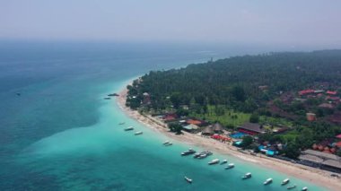 Sahilden ve balıkçı teknelerinden bir arka plan olarak. Üst insansız hava aracının turkuaz su arka planı. Havadan gelen yaz deniz manzarası. Endonezya 'daki Bali Adası. Seyahat videosu