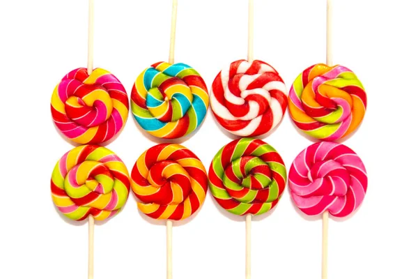 Round multi-colored lollipops on a wooden stick — Stock Photo, Image