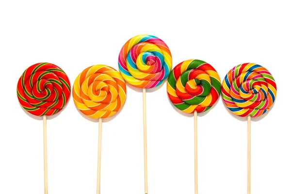 Round multi-colored lollipops on a wooden stick — Stock Photo, Image