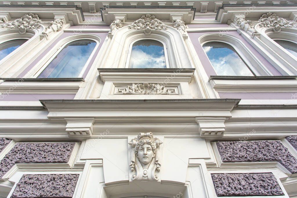 fragment of the facade of a historic building with stucco molding classicism