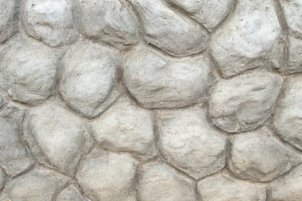 Az épület homlokzatának díszítő határa betonból, nagy kövek formájában — Stock Fotó