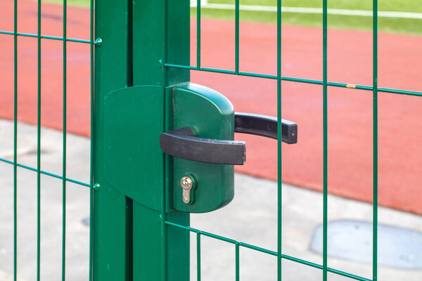 lock and handle on the fence on the street