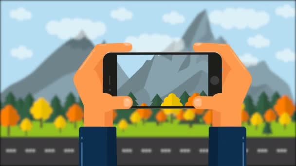 携帯電話で手のアニメーション。写真の風景、森の山 — ストック動画