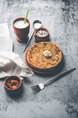 Aloo Paratha / Hint Patatesi üzerine tereyağlı Düz Ekmek. Taze Lassi, turşu ve turşu ile servis edilir. seçici odak