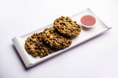 Chana Dal Bhabra / Babra, Hindistan 'ın Bihar / Bhojpur kentinin popüler yemekleri olan domates ketçapıyla servis edildi.