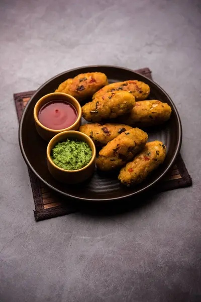 Veg Poha Cutlet or flattened Rice Patties served with tomato ketchup and green chutney