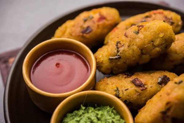 Veg Poha Cutlet or flattened Rice Patties served with tomato ketchup and green chutney