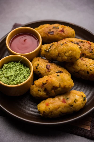 Veg Poha Cutlet or flattened Rice Patties served with tomato ketchup and green chutney