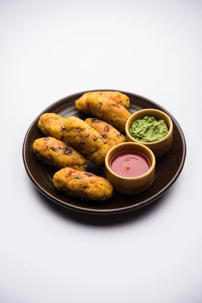 Veg Poha Cutlet or flattened Rice Patties served with tomato ketchup and green chutney