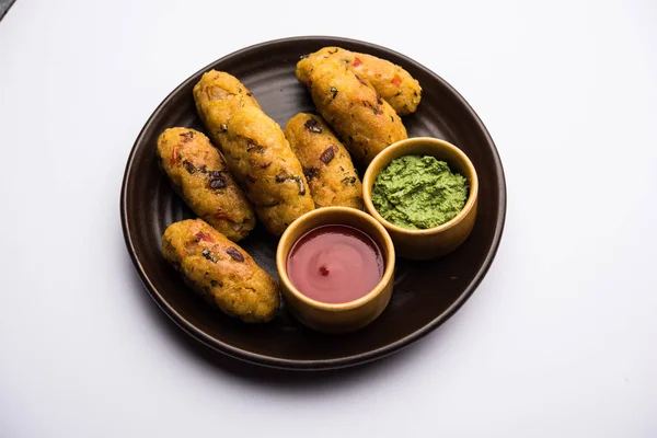 Veg Poha Cutlet or flattened Rice Patties served with tomato ketchup and green chutney