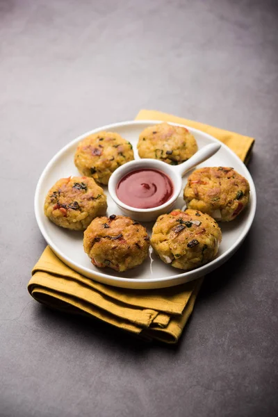 Veg Poha Cutlet or flattened Rice Patties served with tomato ketchup and green chutney