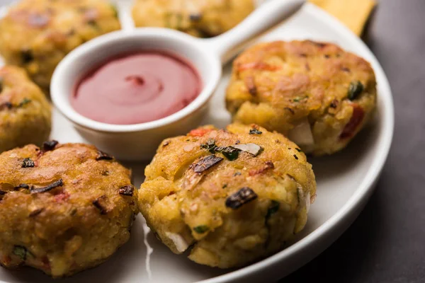 Veg Poha Cutlet or flattened Rice Patties served with tomato ketchup and green chutney