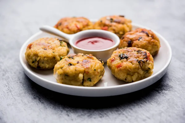 Veg Poha Cutlet or flattened Rice Patties served with tomato ketchup and green chutney