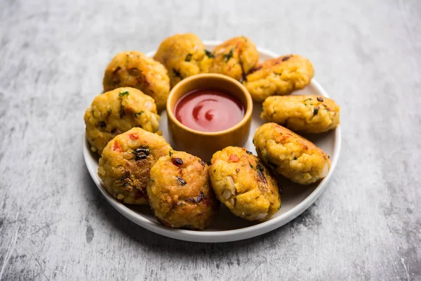 Veg Poha Cutlet or flattened Rice Patties served with tomato ketchup and green chutney