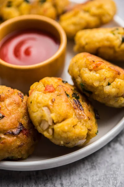 Veg Poha Cutlet or flattened Rice Patties served with tomato ketchup and green chutney