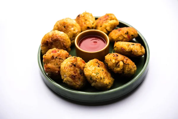 Veg Poha Cutlet or flattened Rice Patties served with tomato ketchup and green chutney