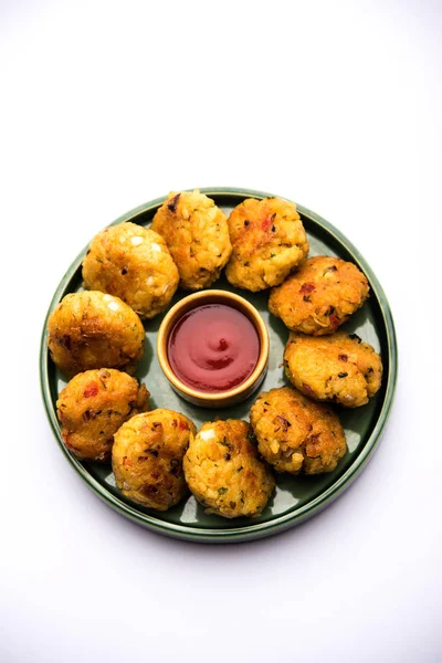 Veg Poha Cutlet or flattened Rice Patties served with tomato ketchup and green chutney