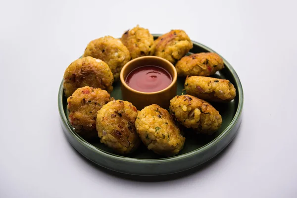 Veg Poha Cutlet or flattened Rice Patties served with tomato ketchup and green chutney