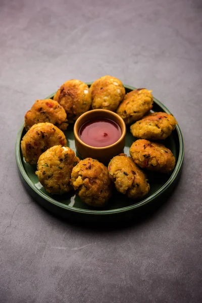 Veg Poha Cutlet or flattened Rice Patties served with tomato ketchup and green chutney