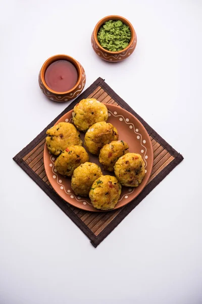 Veg Poha Cutlet or flattened Rice Patties served with tomato ketchup and green chutney