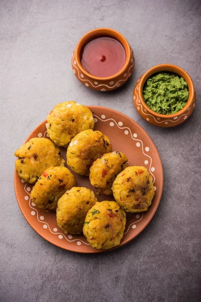 Veg Poha Cutlet or flattened Rice Patties served with tomato ketchup and green chutney