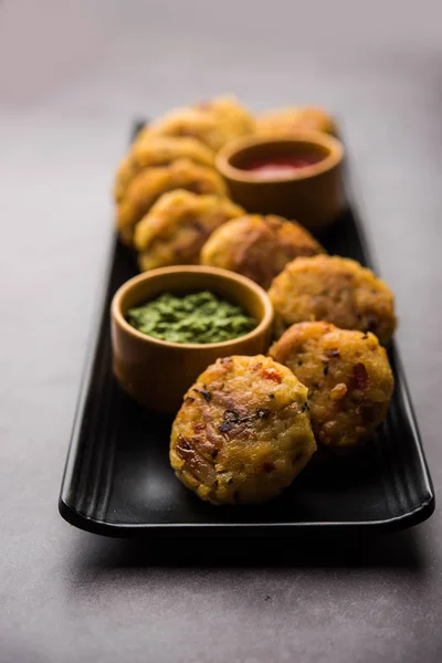 Veg Poha Cutlet or flattened Rice Patties served with tomato ketchup and green chutney