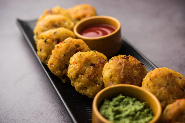 Veg Poha Cutlet or flattened Rice Patties served with tomato ketchup and green chutney