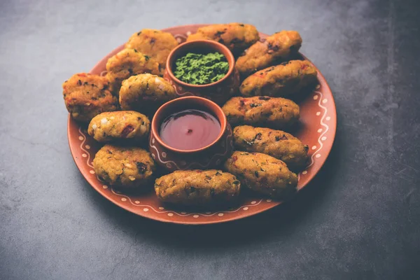 Veg Poha Cutlet or flattened Rice Patties served with tomato ketchup and green chutney