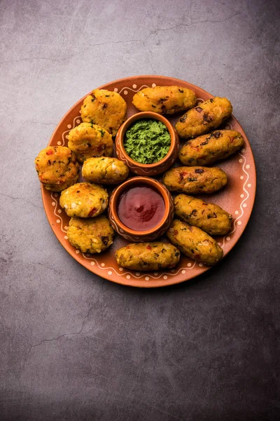 Veg Poha Cutlet or flattened Rice Patties served with tomato ketchup and green chutney