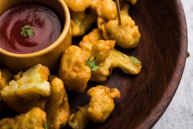 Gobi Pakora ya da Phoolgobi Pakoda taze nohut soslu nohut hamuru kullanıp yağda kızarttı. Domates ketçap ve nane sosuyla servis edilir. seçici odak