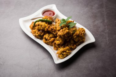 Çıtır mısır pakora / pakoda, bhajji, Bhaji, bajji veya pattice. Domates ve ketçap ile servis edilir.