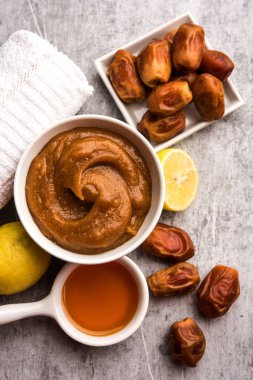 Yumuşak, pürüzsüz ve pürüzsüz cilt maskesi ve taze çiğ khajoor, limon ve bal gibi renkler. seçici odak