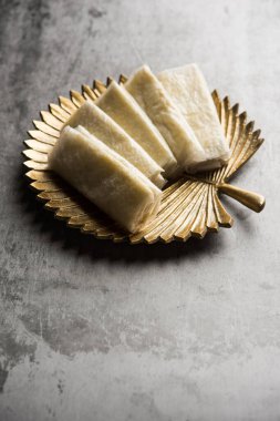 Pootharekulu  is a popular recipe originated from Andhra Pradesh, India.It is a paper-thin sweet or dessert made from rice start/gram flour, jaggery/sugar and clarified butter. Served in a plate.
